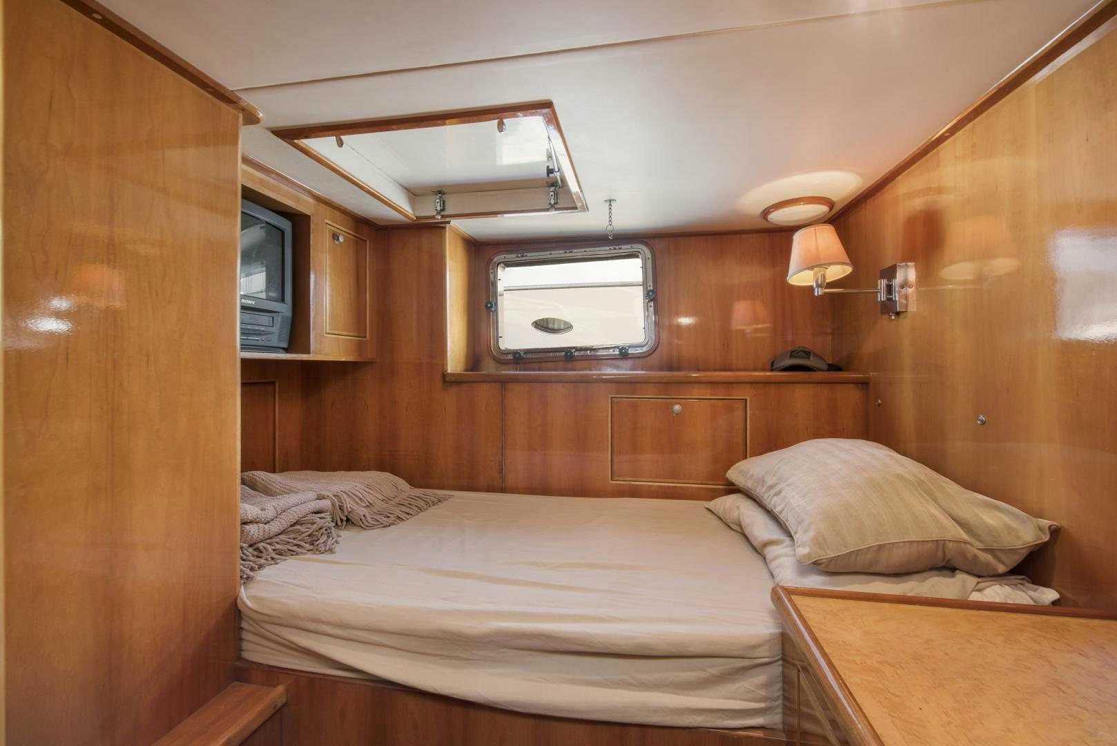 a room with a bed and a television aboard LEGACY Yacht for Sale