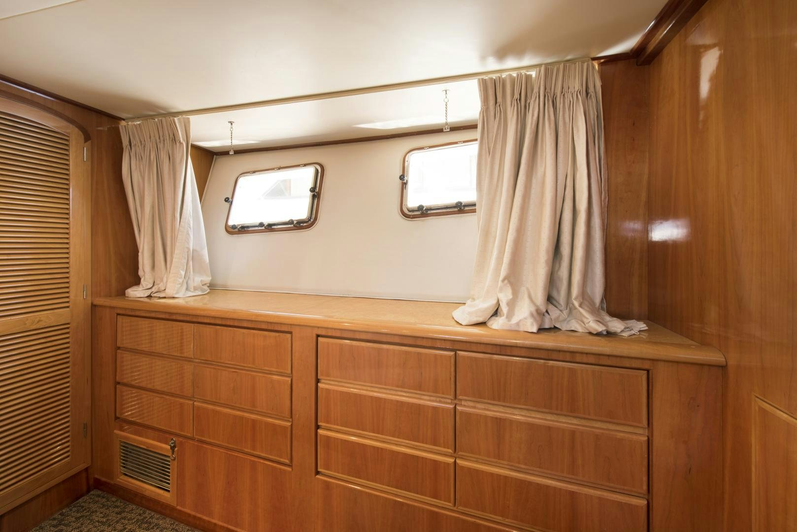a room with a television and a dresser aboard LEGACY Yacht for Sale