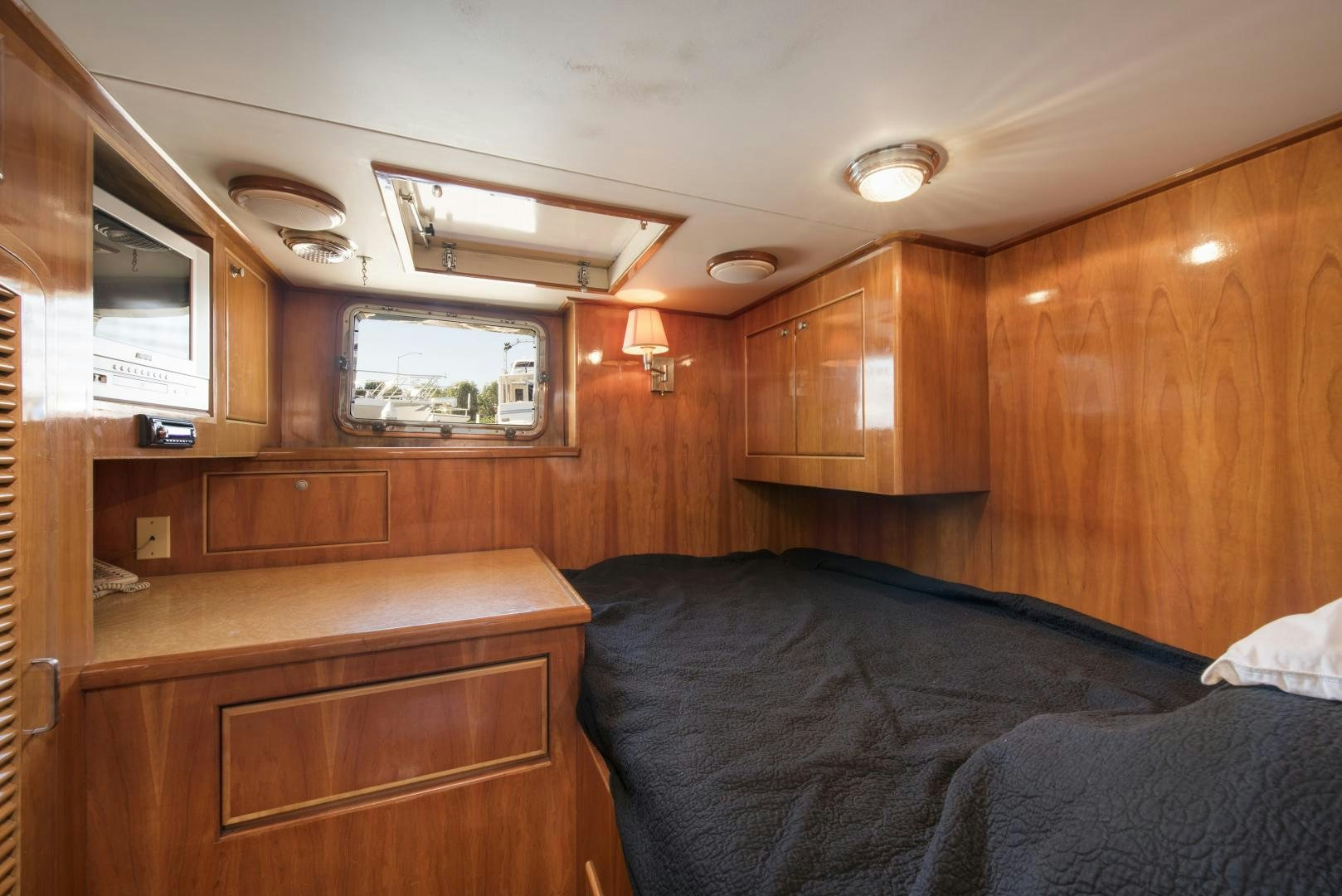 a cabin with a bed and a desk aboard LEGACY Yacht for Sale