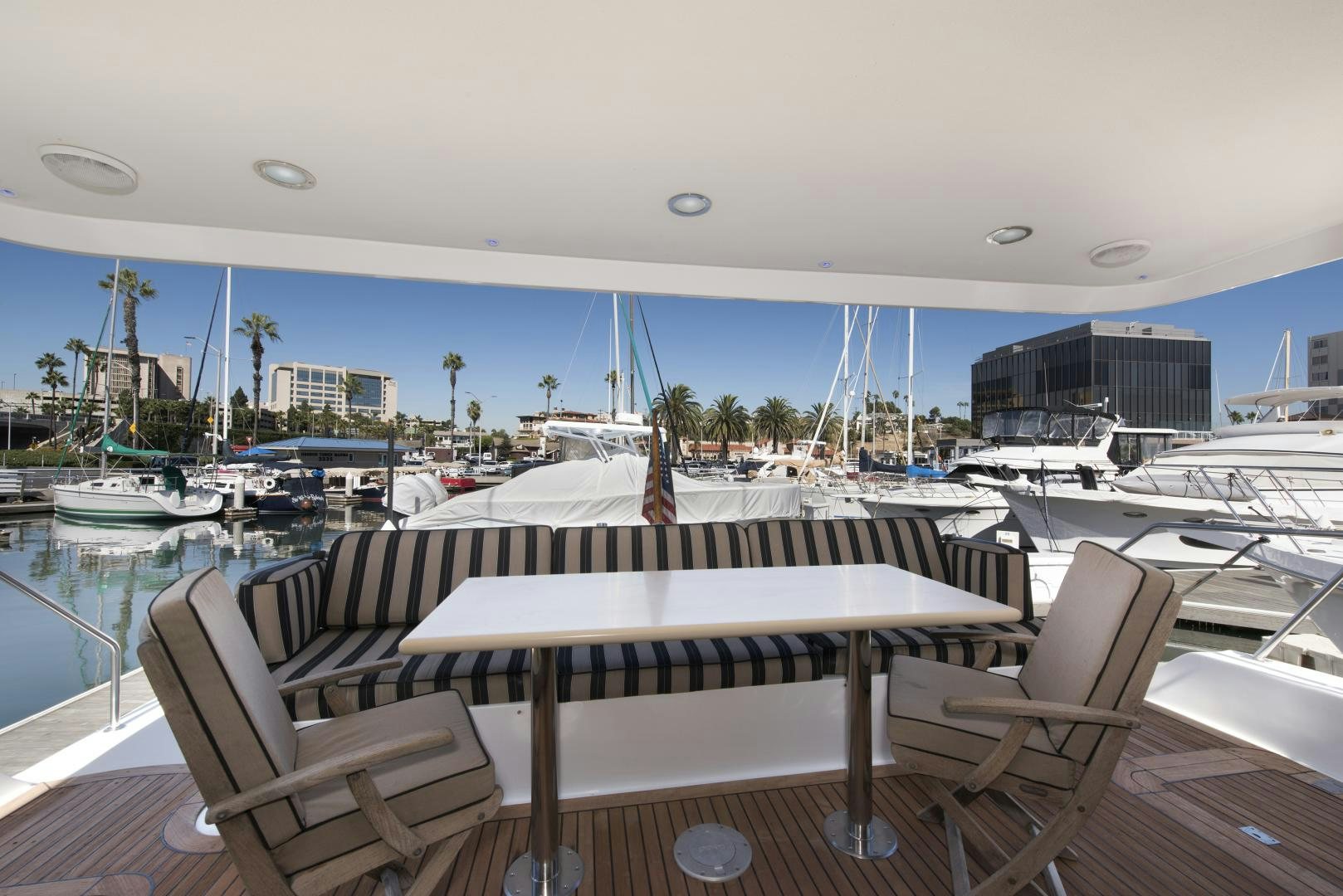 a table and chairs on a deck aboard LEGACY Yacht for Sale