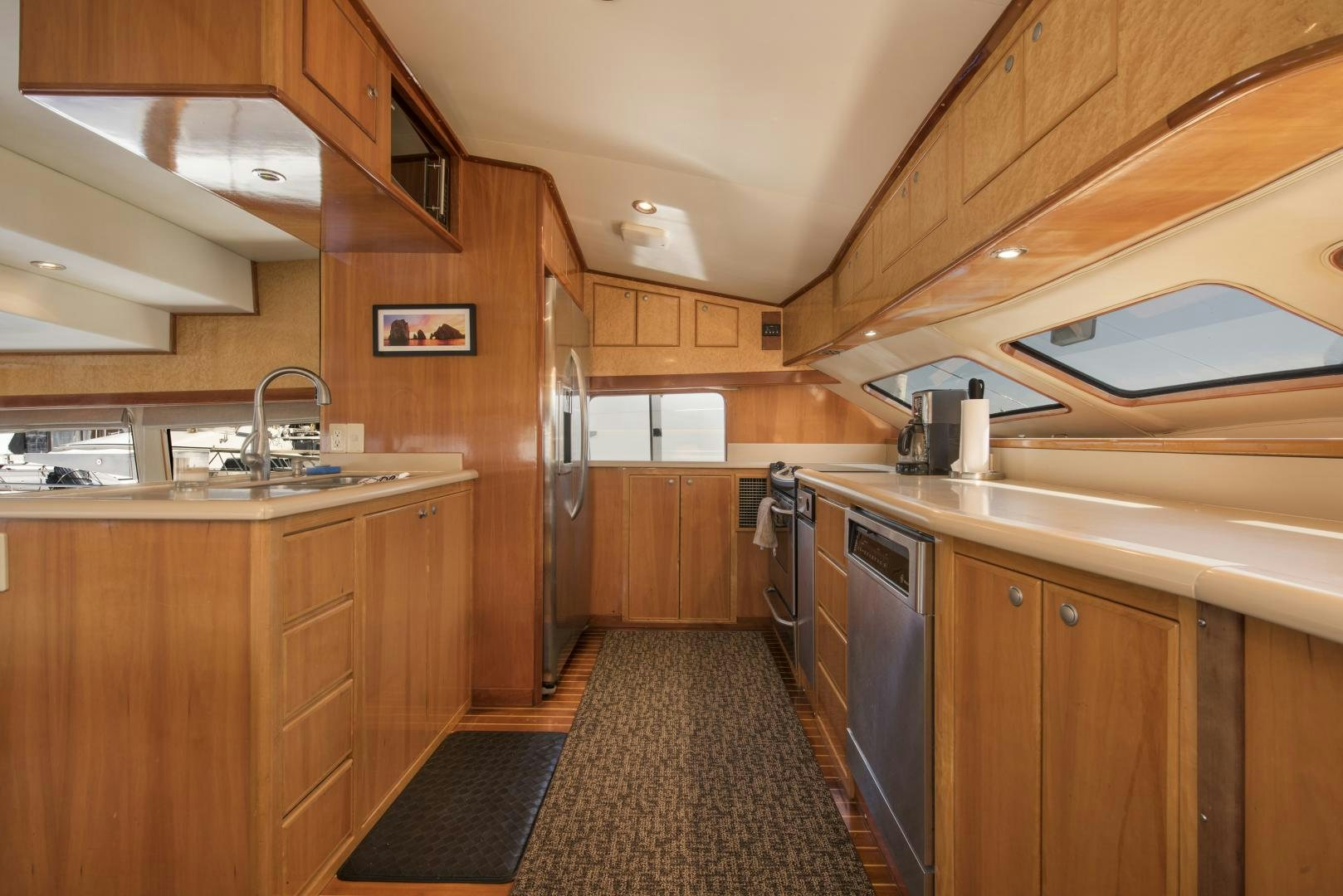 a kitchen with wooden cabinets aboard LEGACY Yacht for Sale