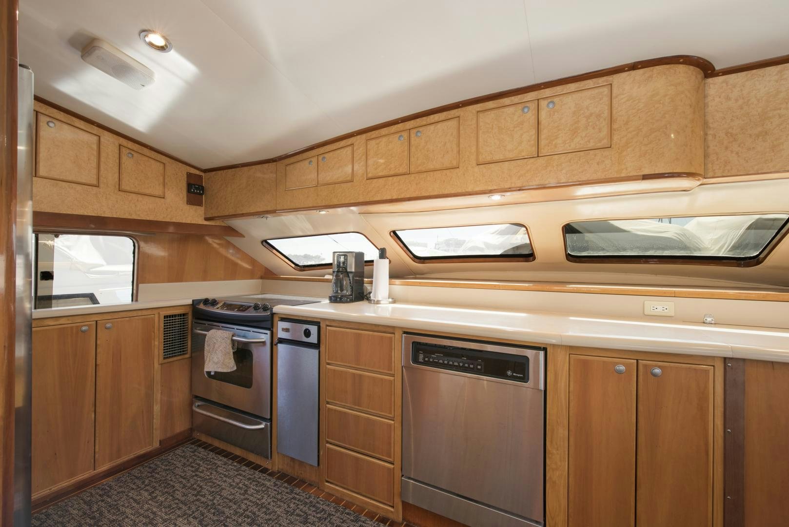 a kitchen with wooden cabinets aboard LEGACY Yacht for Sale
