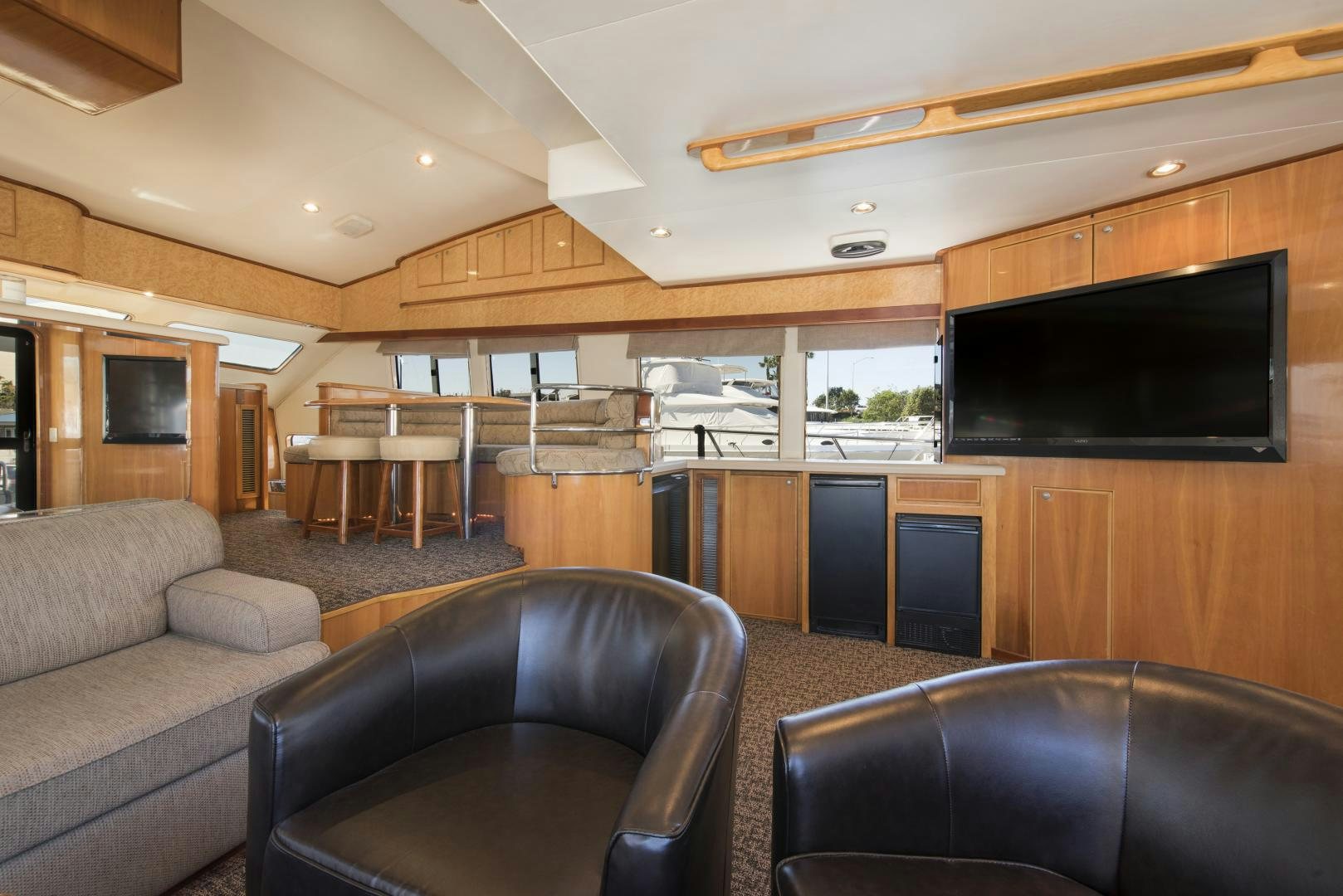 a living room with a couch and a tv aboard LEGACY Yacht for Sale