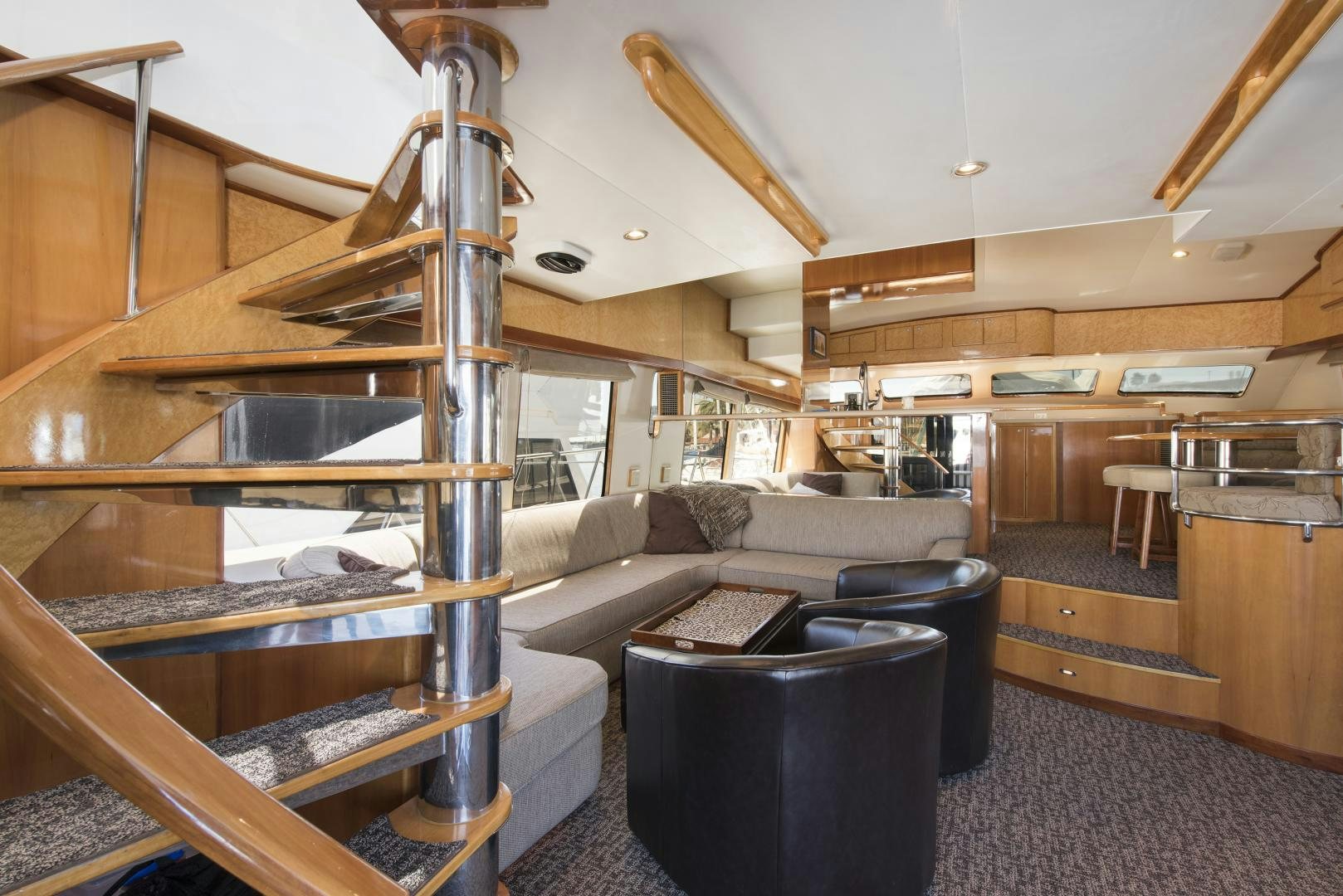 a living room with a wood staircase aboard LEGACY Yacht for Sale