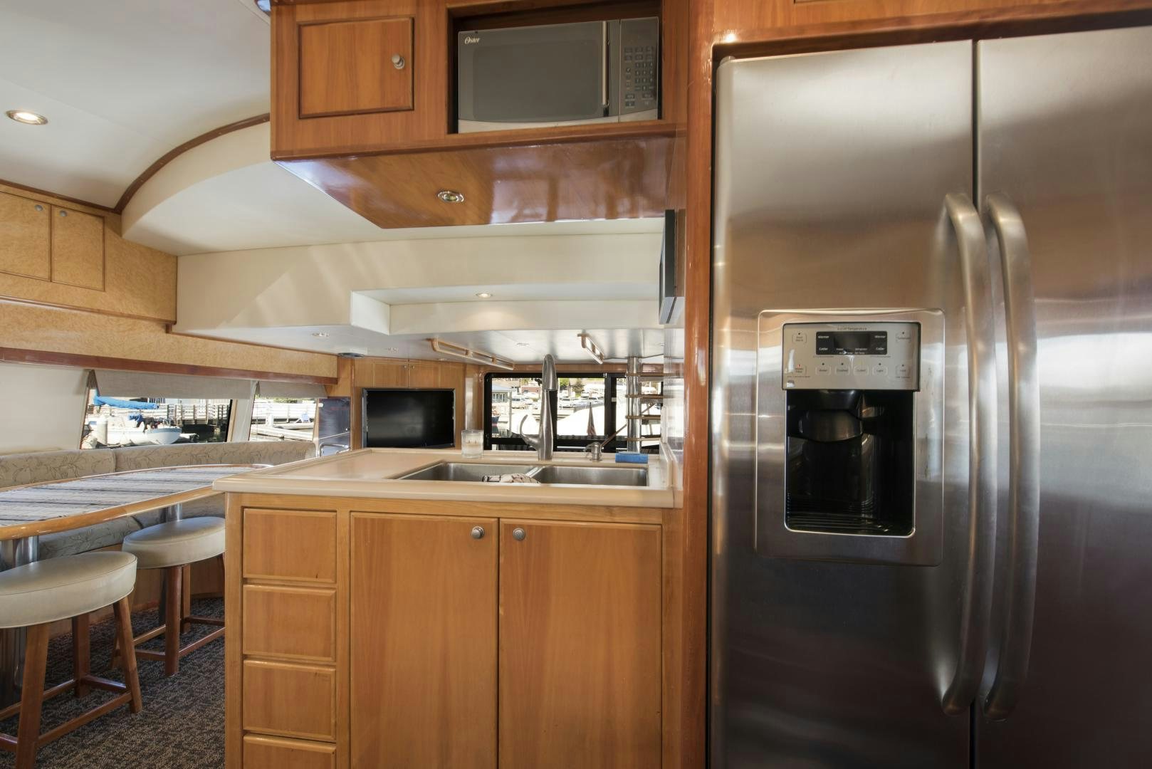 a kitchen with a stainless steel refrigerator aboard LEGACY Yacht for Sale