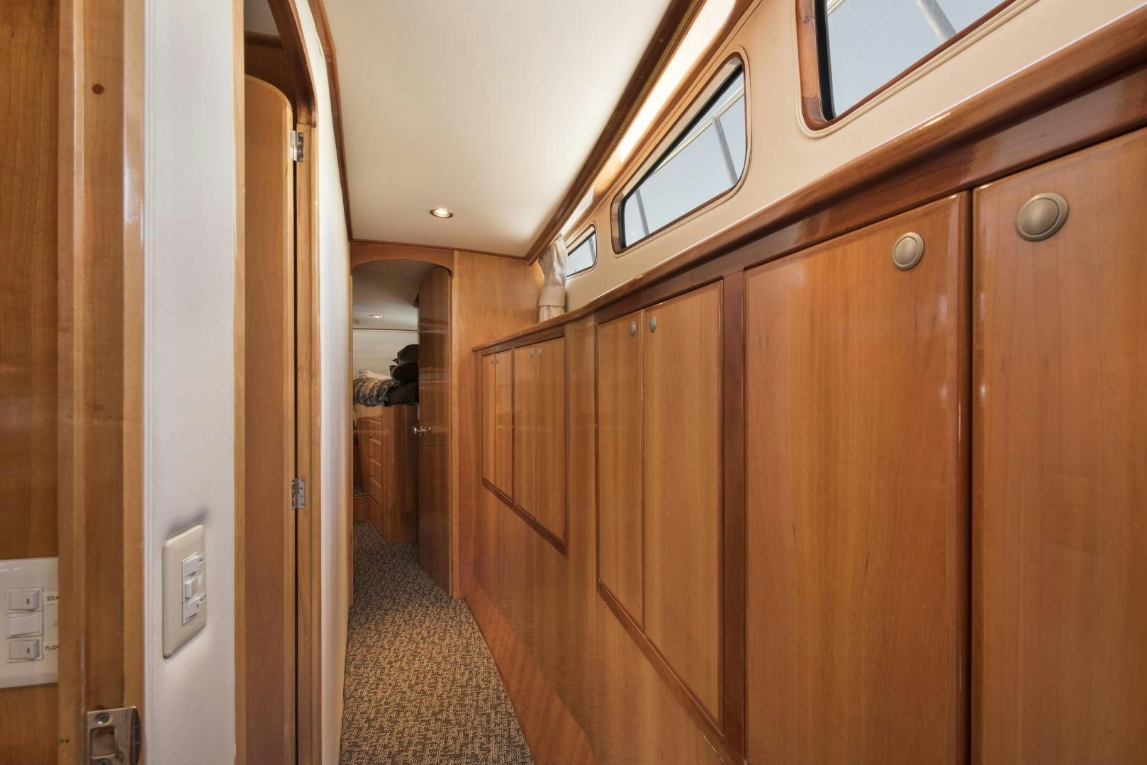 a hallway with wooden cabinets aboard LEGACY Yacht for Sale