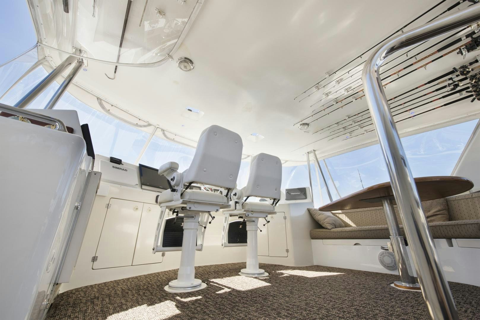 a white yacht with a chair aboard LEGACY Yacht for Sale