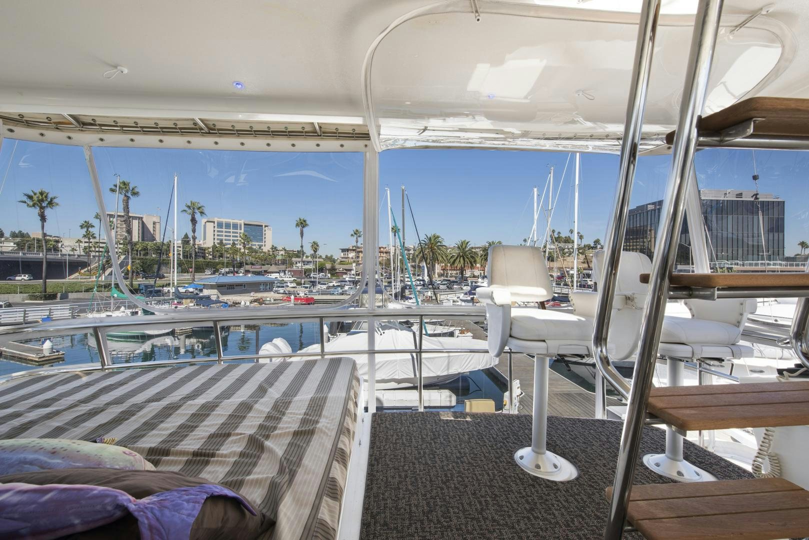 a boat deck with chairs and a table on it aboard LEGACY Yacht for Sale