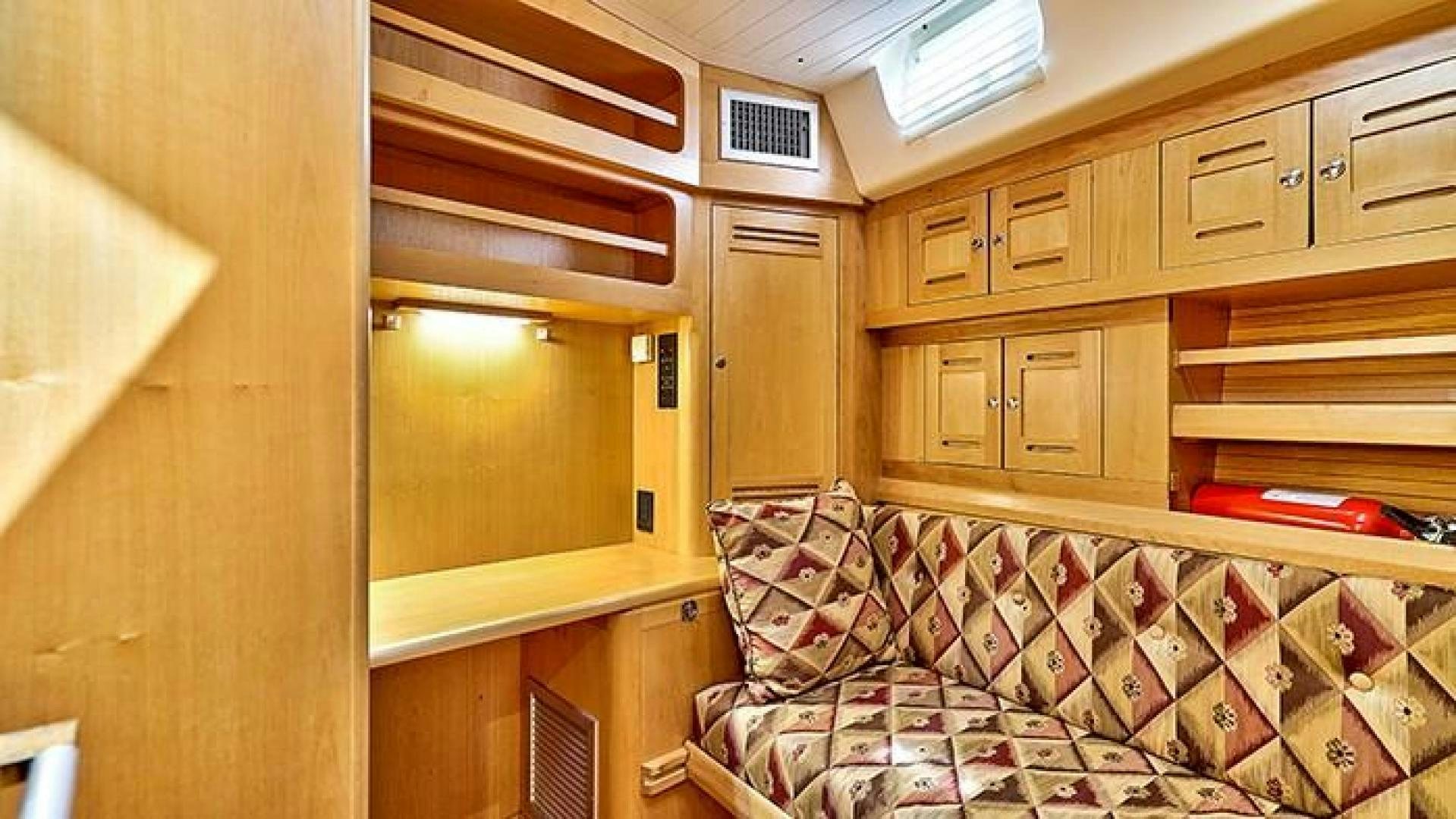 a room with a bed and cabinets aboard MAYA Yacht for Sale
