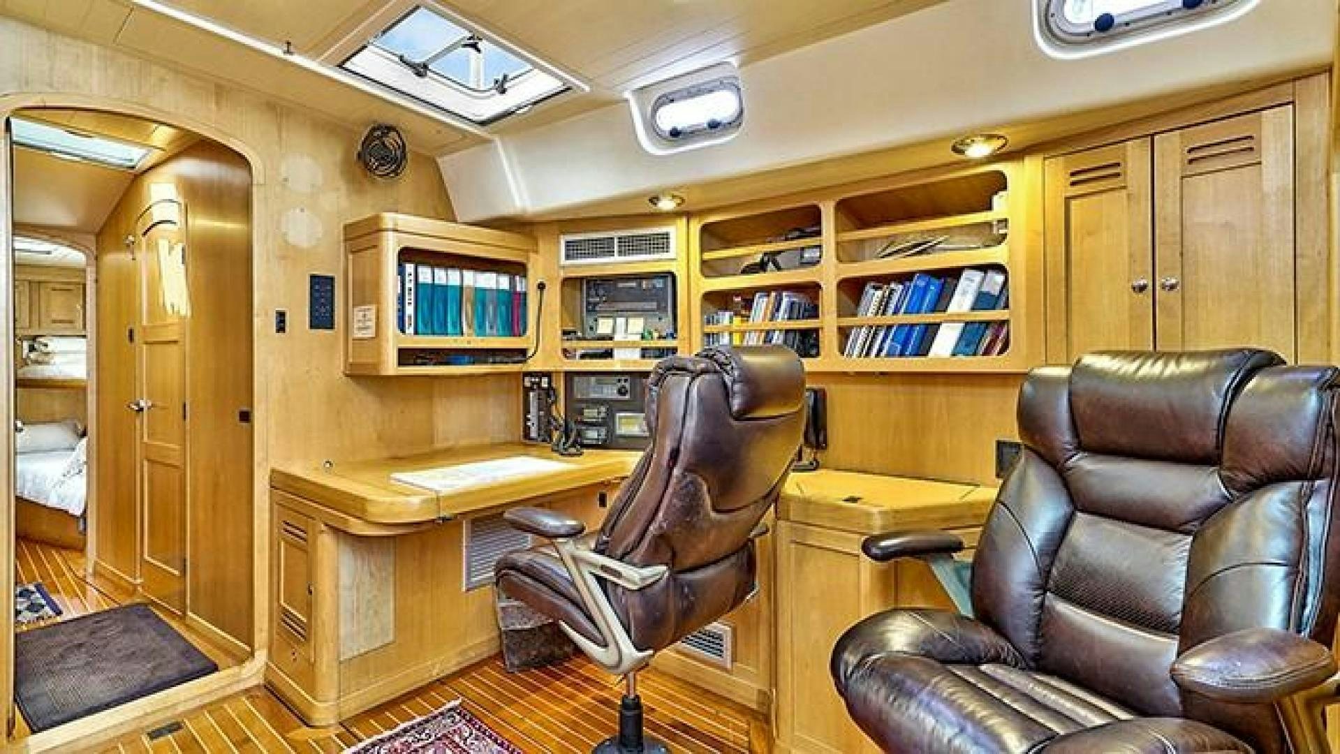 a room with a desk and chairs aboard MAYA Yacht for Sale