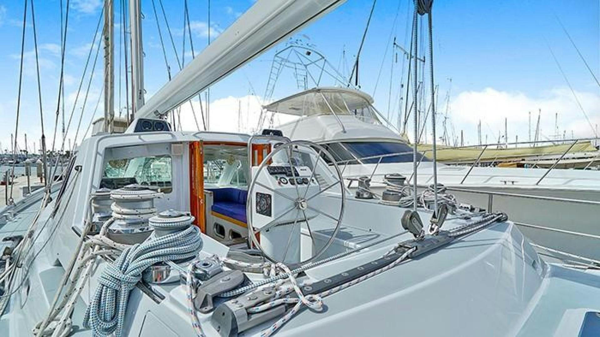 a white boat with a blue stripe on it aboard MAYA Yacht for Sale