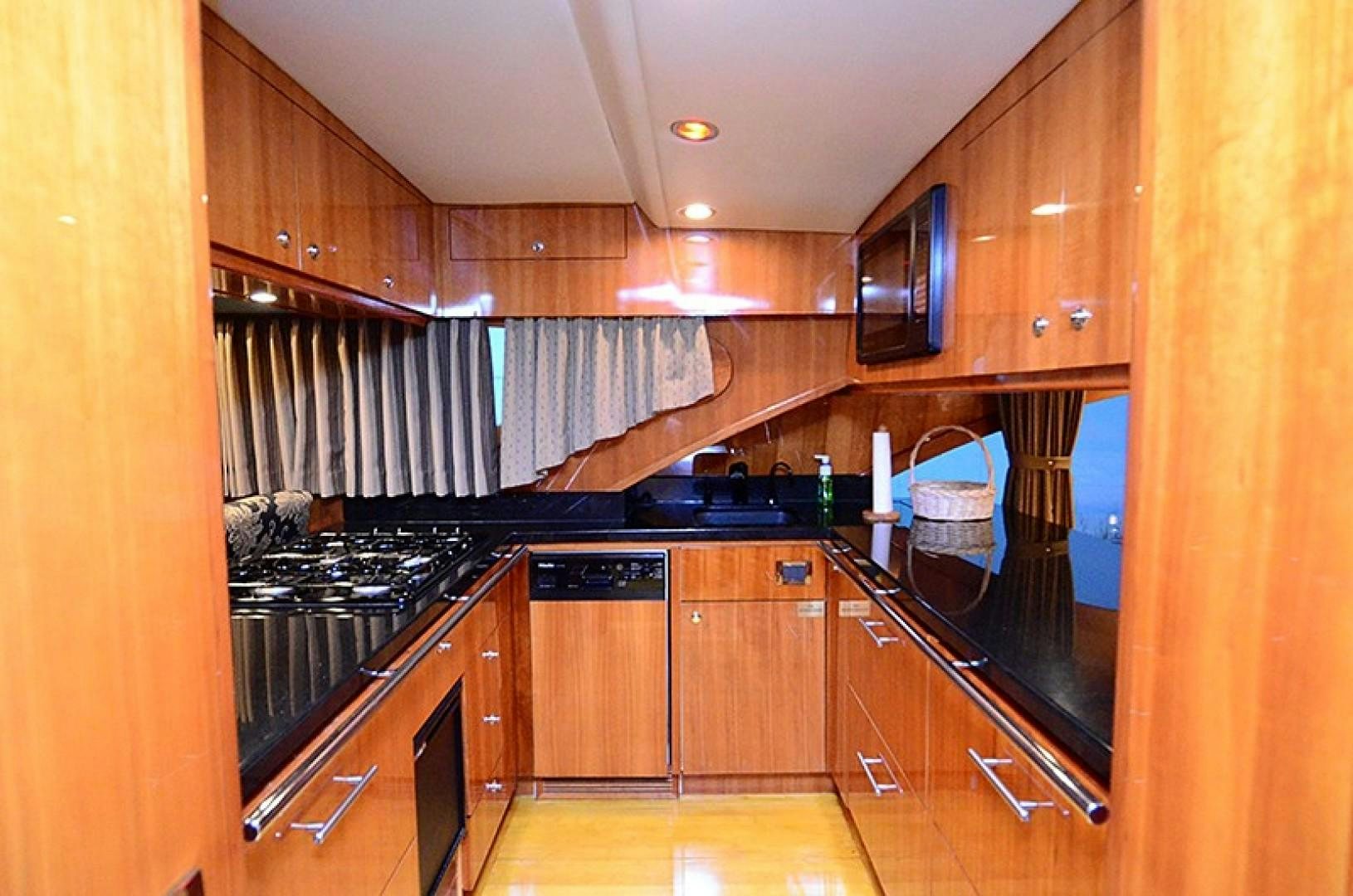 a kitchen with black appliances aboard 4 PRINCESSES Yacht for Sale