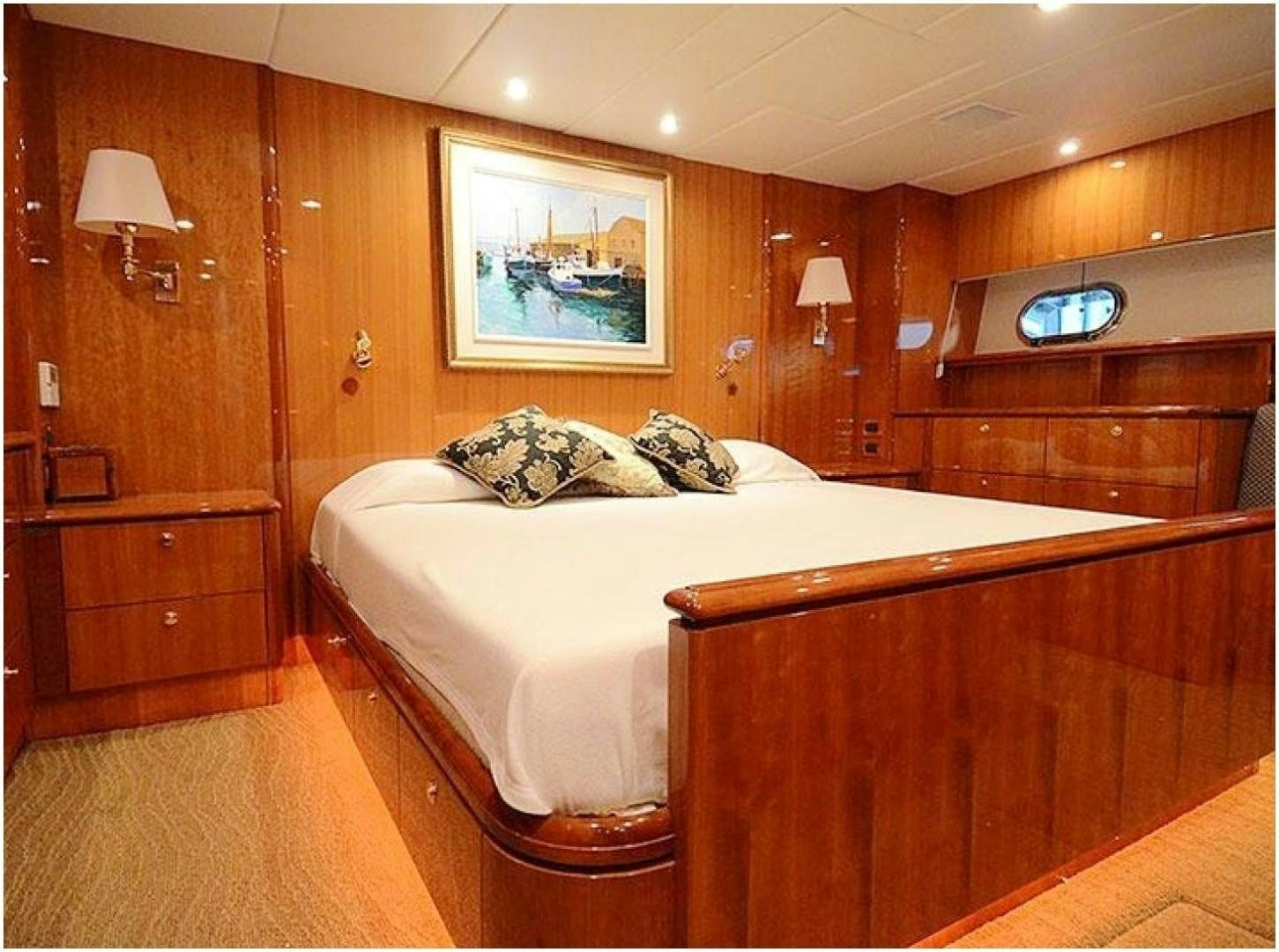 a bedroom with a bed and a lamp aboard 4 PRINCESSES Yacht for Sale