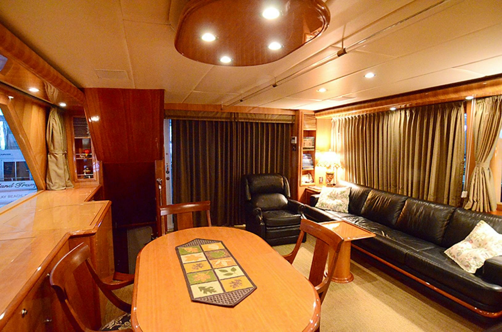 a living room with a leather couch and a table aboard 4 PRINCESSES Yacht for Sale