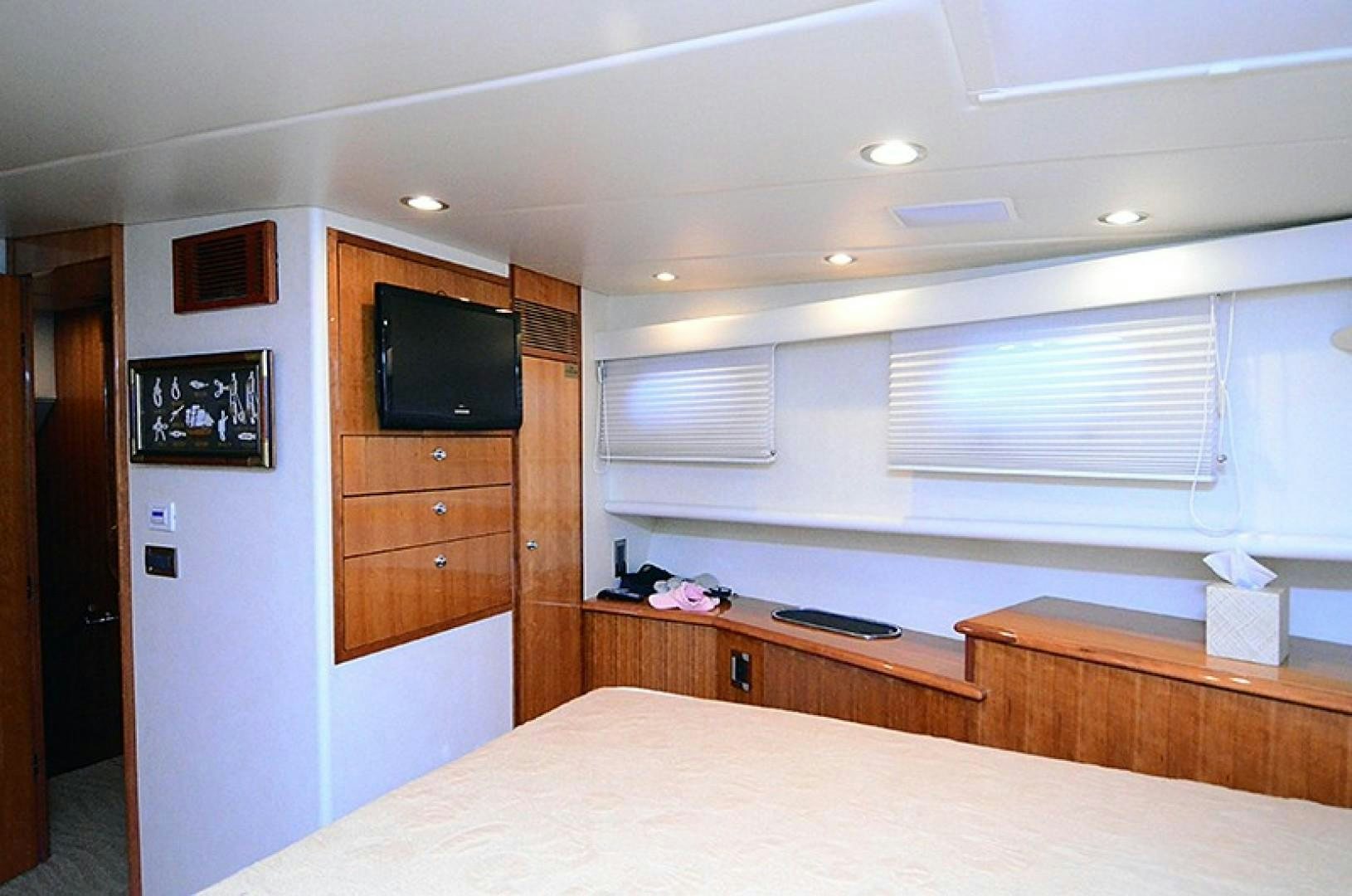 a bedroom with a bed and a television aboard 4 PRINCESSES Yacht for Sale