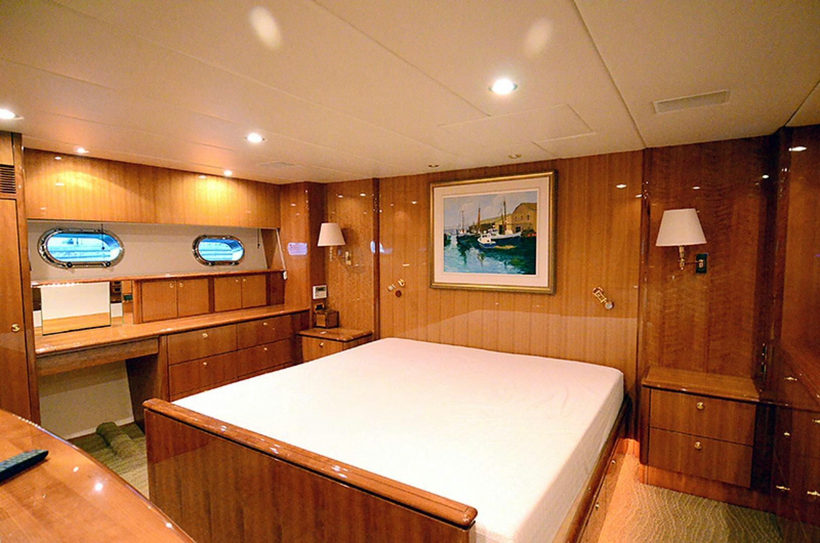 a bedroom with a bed and a desk aboard 4 PRINCESSES Yacht for Sale