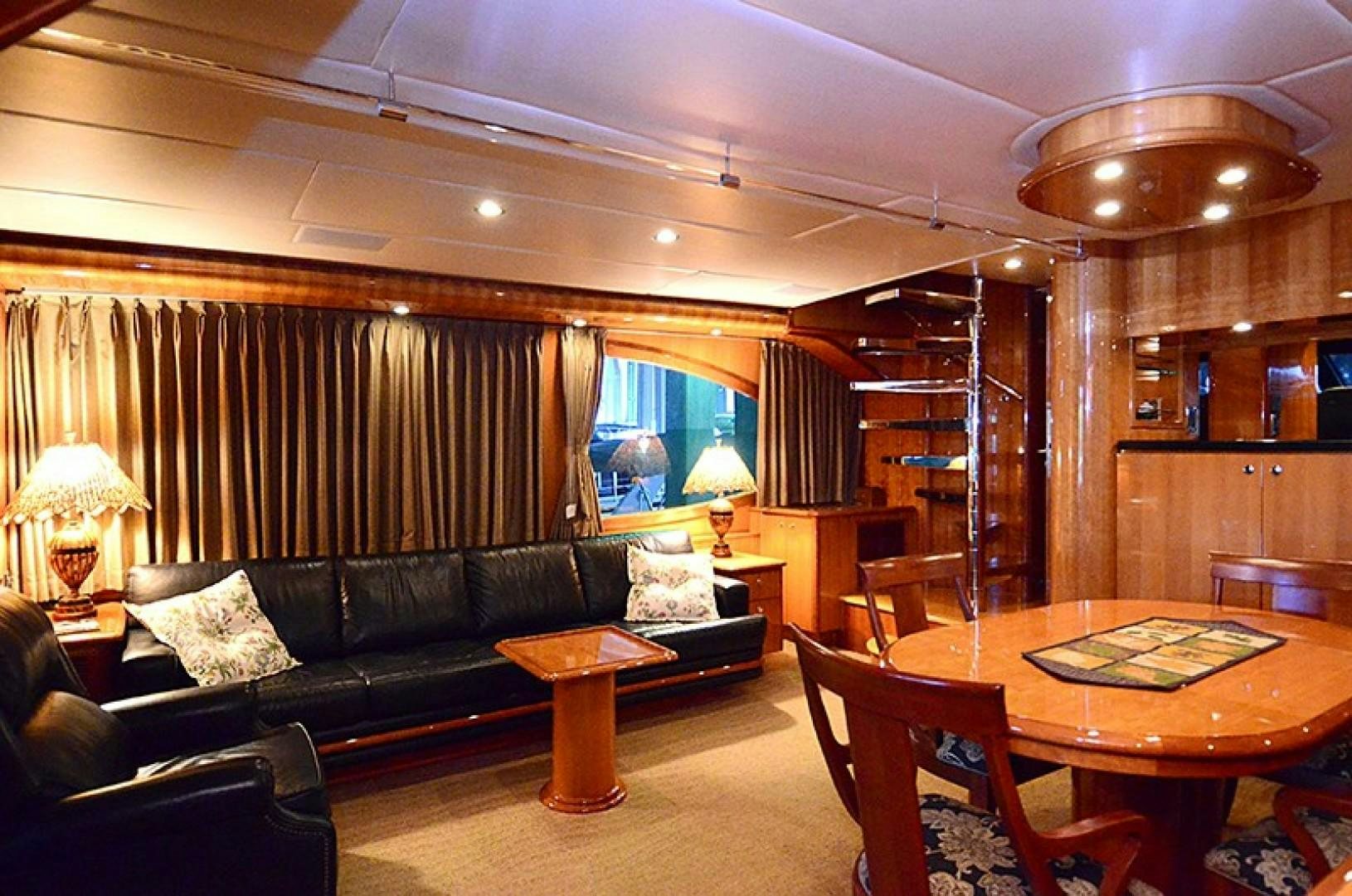 a living room with a black couch and a wood table aboard 4 PRINCESSES Yacht for Sale