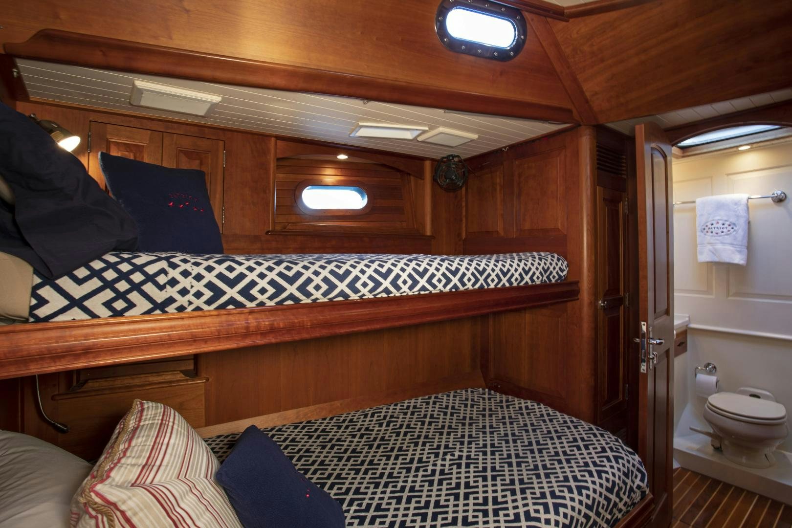 a bed with a wood frame aboard PATRIOT  Yacht for Sale