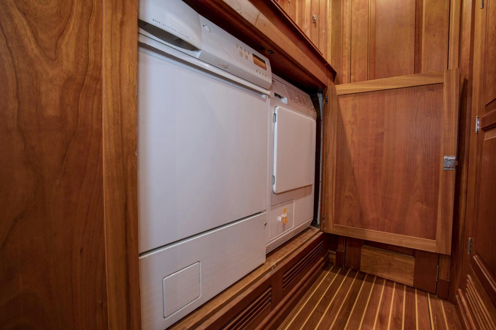a white refrigerator in a wooden cabinet aboard PATRIOT  Yacht for Sale