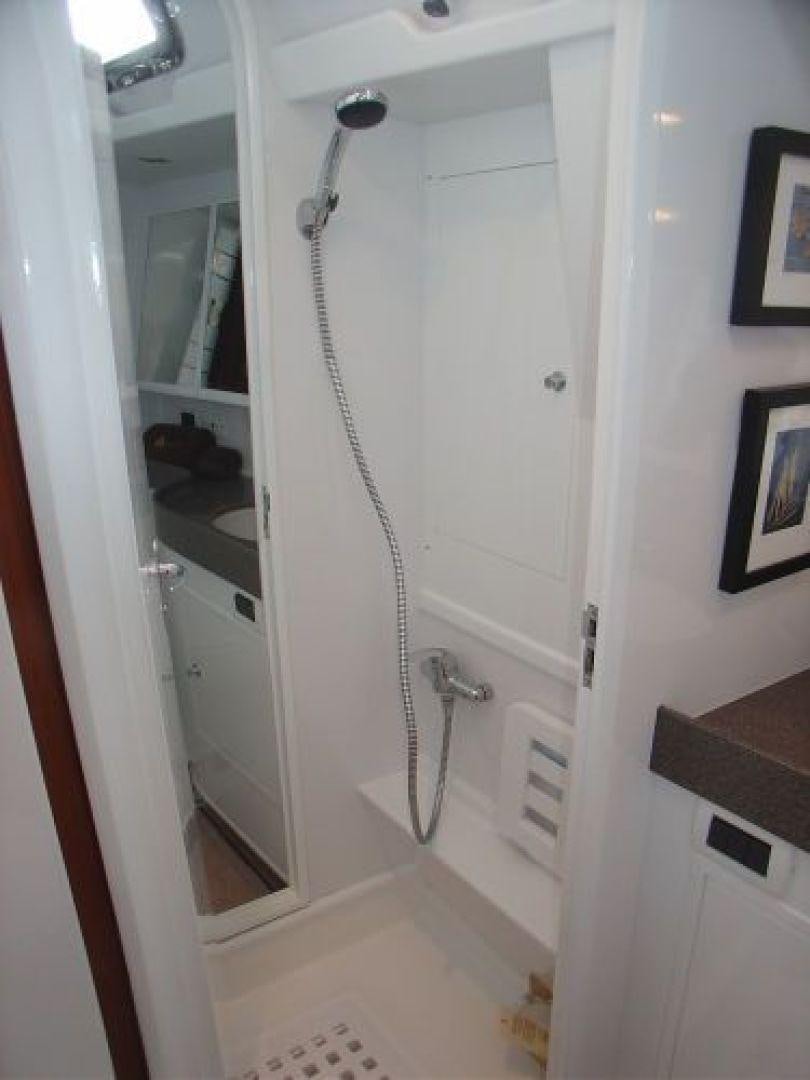 a shower unit with a sink and mirror aboard amante Yacht for Sale