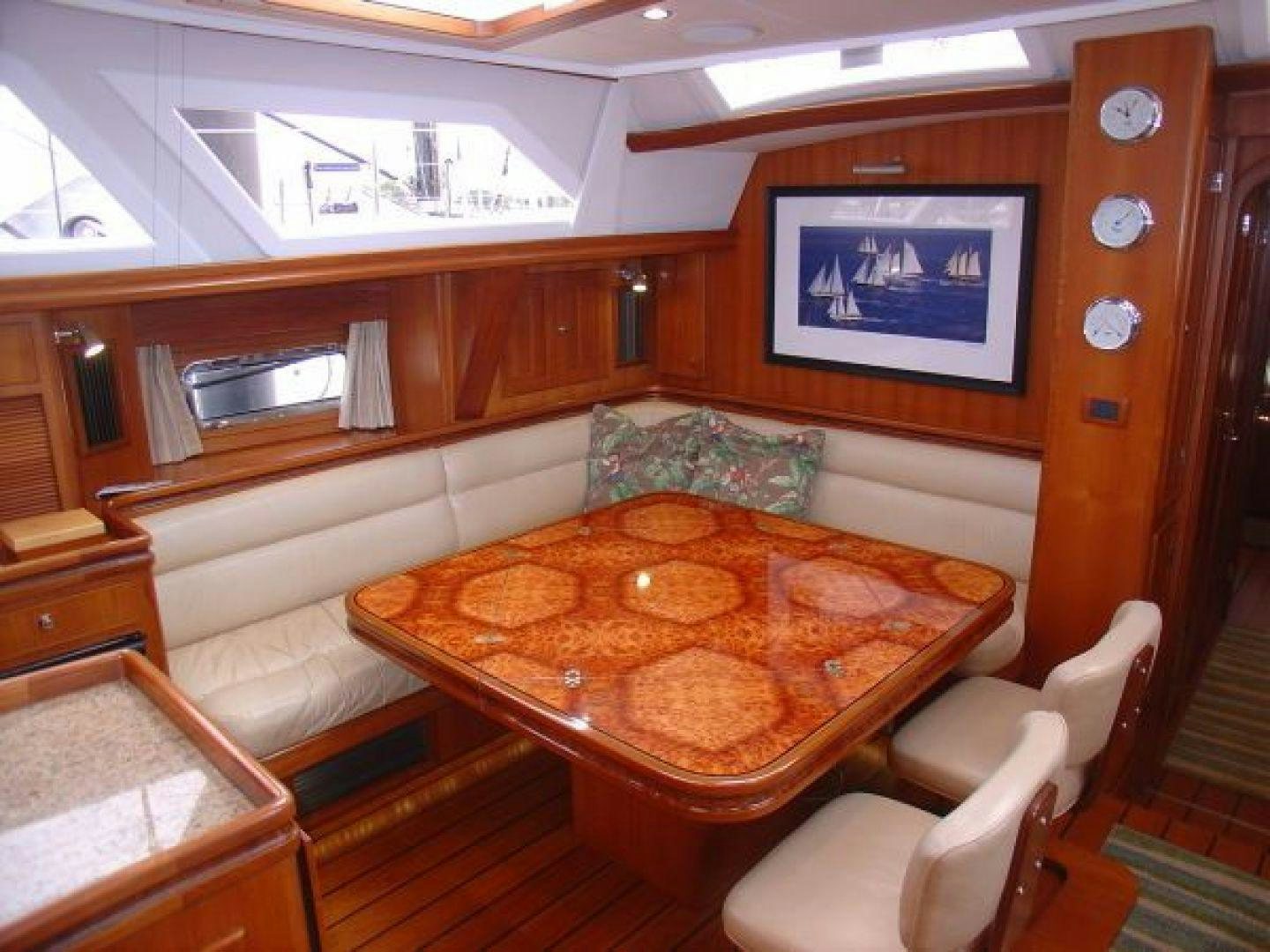 a kitchen with a table and chairs aboard amante Yacht for Sale