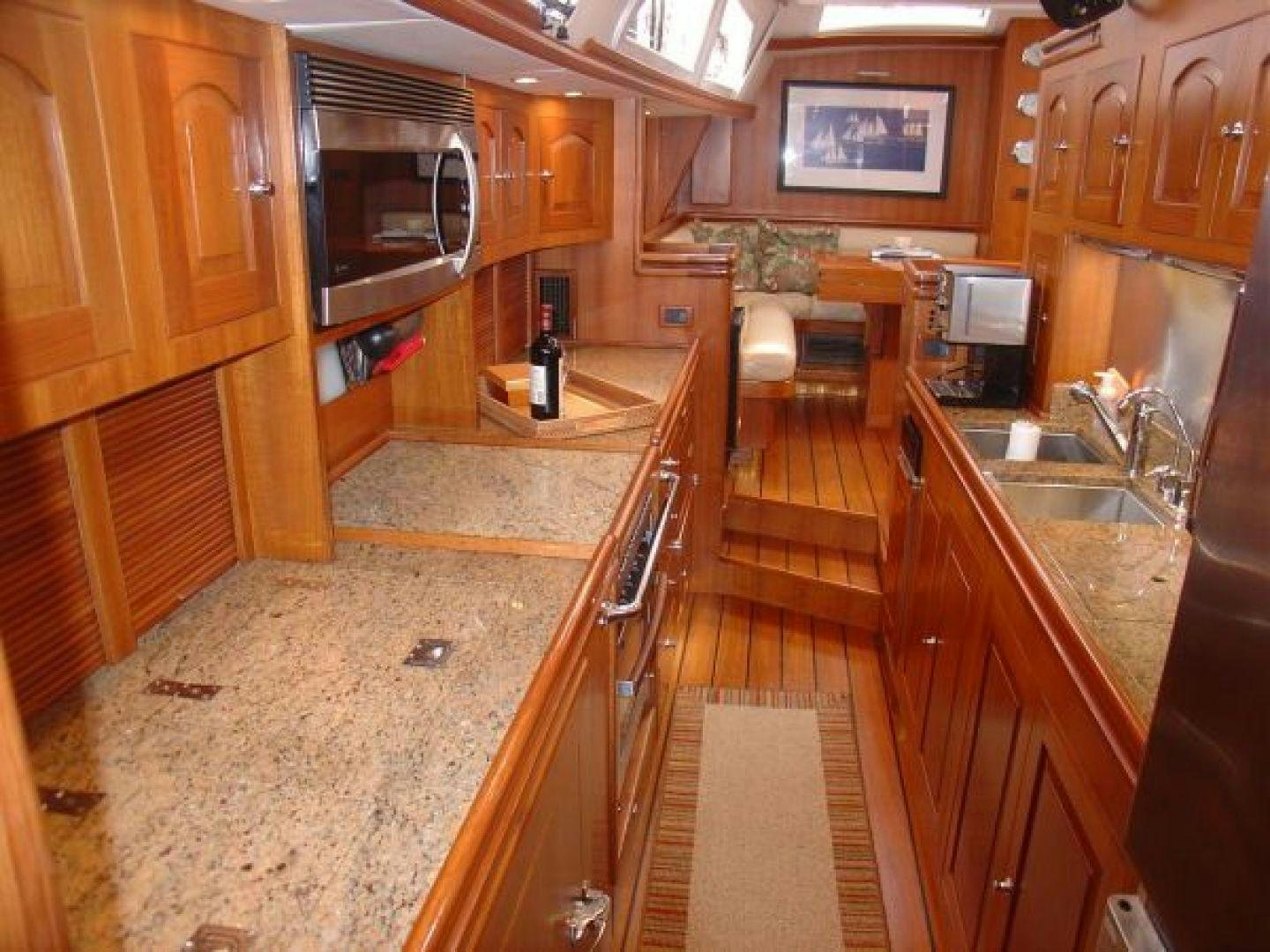 a kitchen with wooden cabinets aboard amante Yacht for Sale