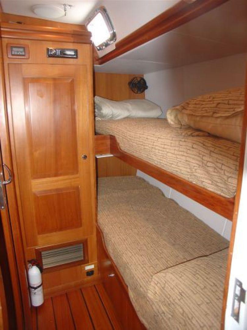 a room with a couple of beds aboard amante Yacht for Sale