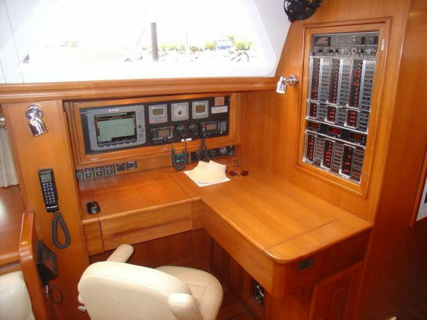 a wooden desk with a computer and a chair aboard amante Yacht for Sale