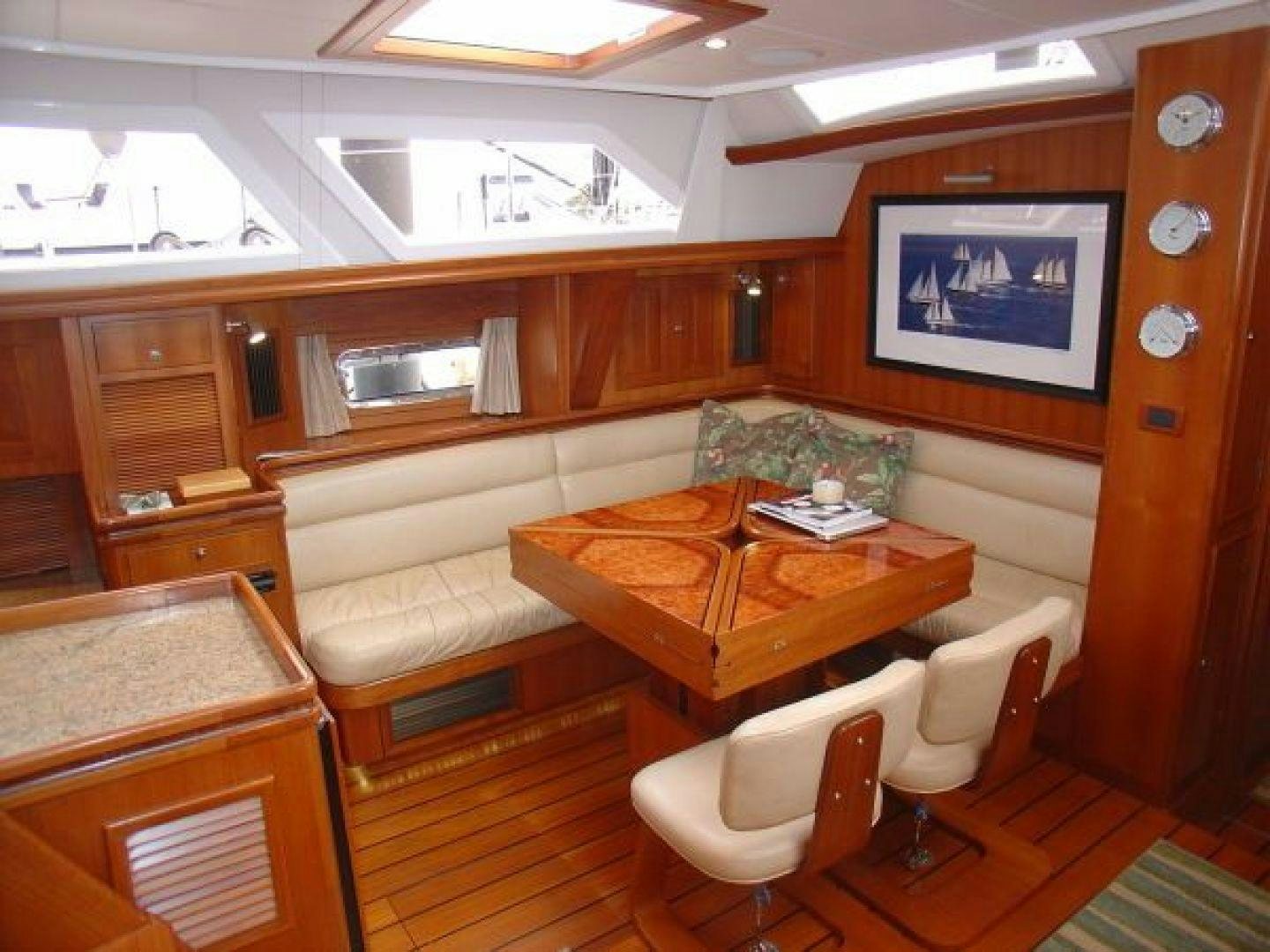 a room with a table and chairs aboard amante Yacht for Sale
