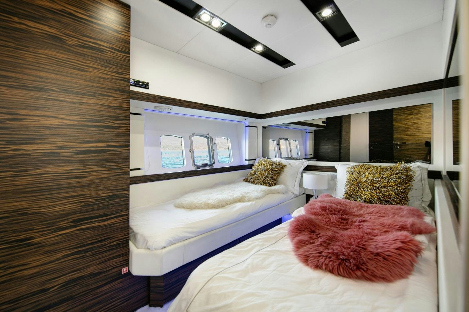 a room with a couple of beds aboard OCEAN TIGER Yacht for Sale