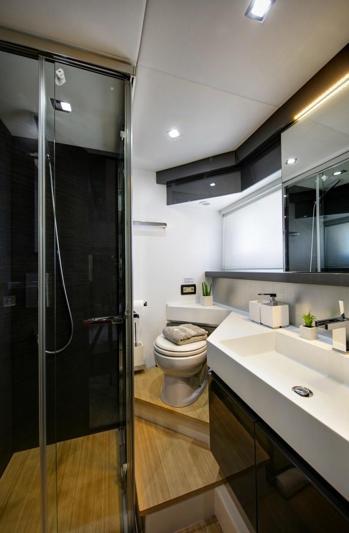a bathroom with a glass shower door aboard OCEAN TIGER Yacht for Sale