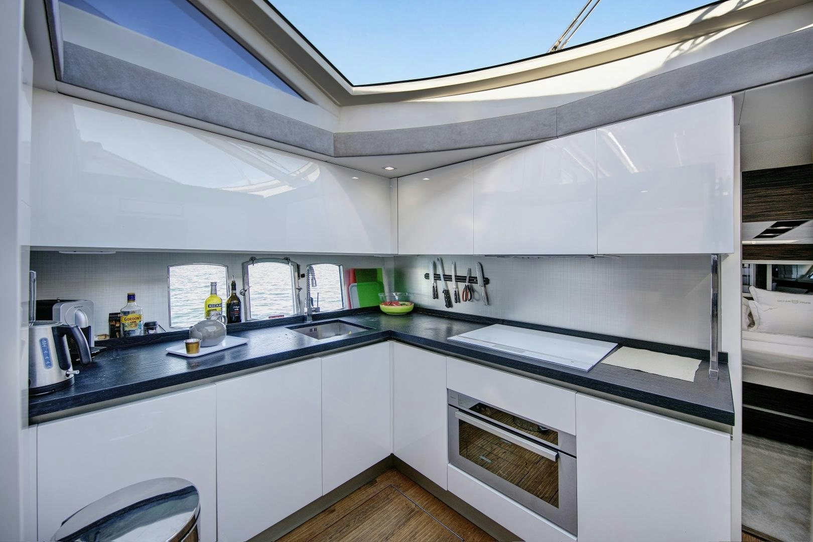 a kitchen with white cabinets aboard OCEAN TIGER Yacht for Sale