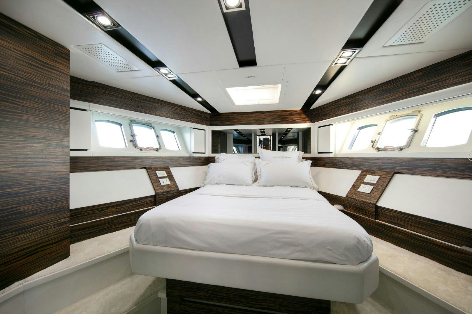 a room with a bed and a window aboard OCEAN TIGER Yacht for Sale
