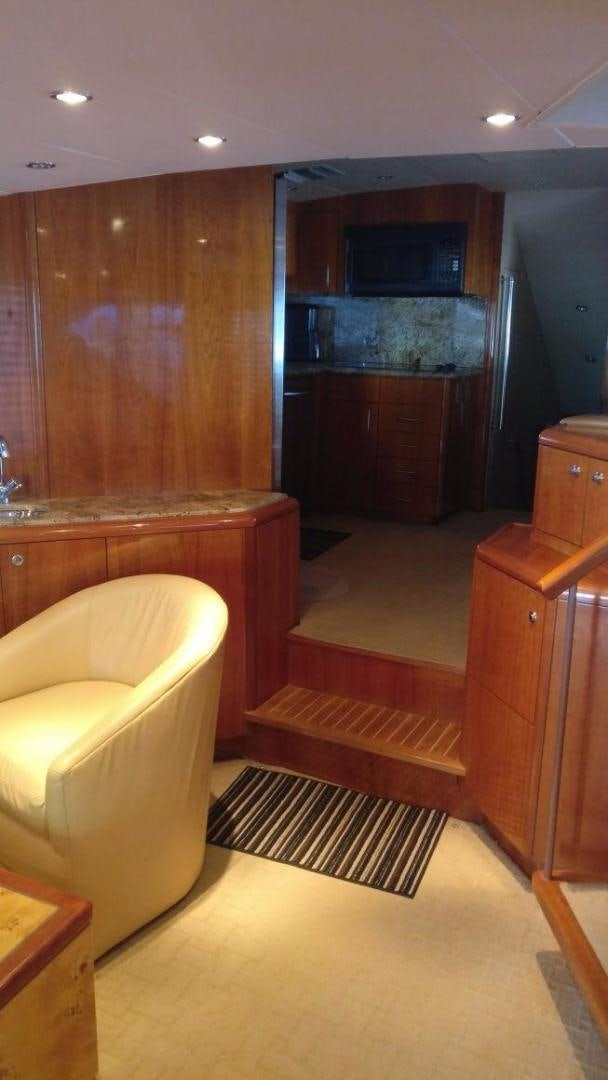 a living room with a wood cabinet aboard SOLE RETREAT Yacht for Sale