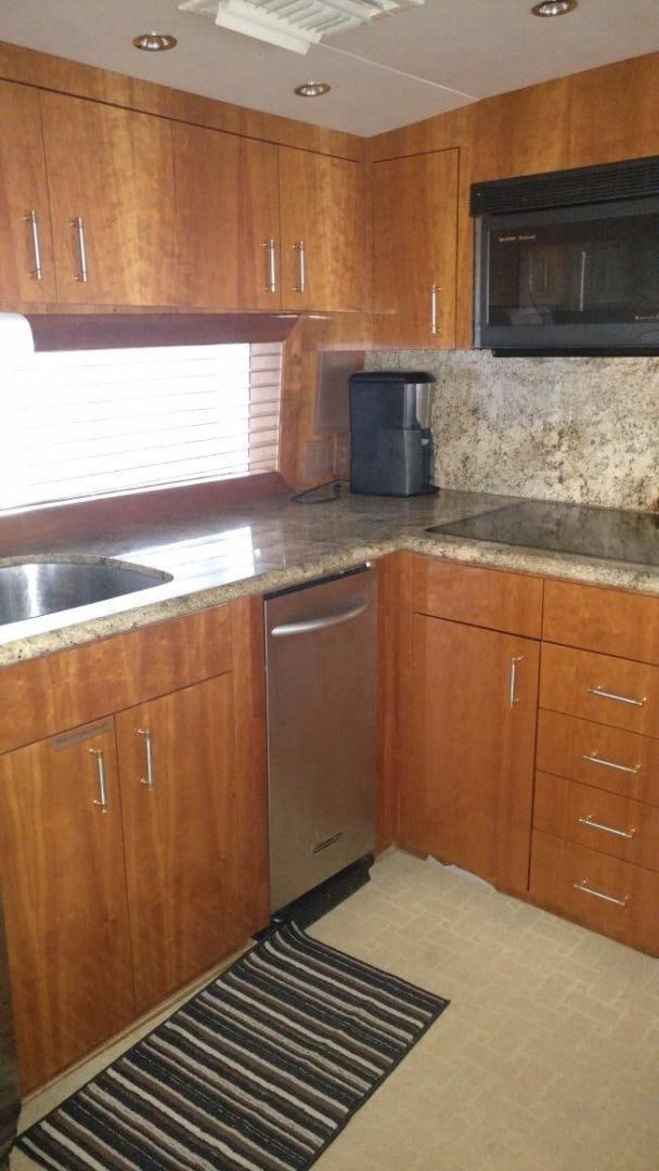 a kitchen with wooden cabinets aboard SOLE RETREAT Yacht for Sale