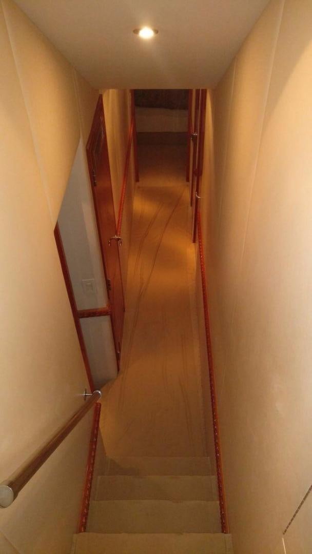 a hallway with a wood door aboard SOLE RETREAT Yacht for Sale