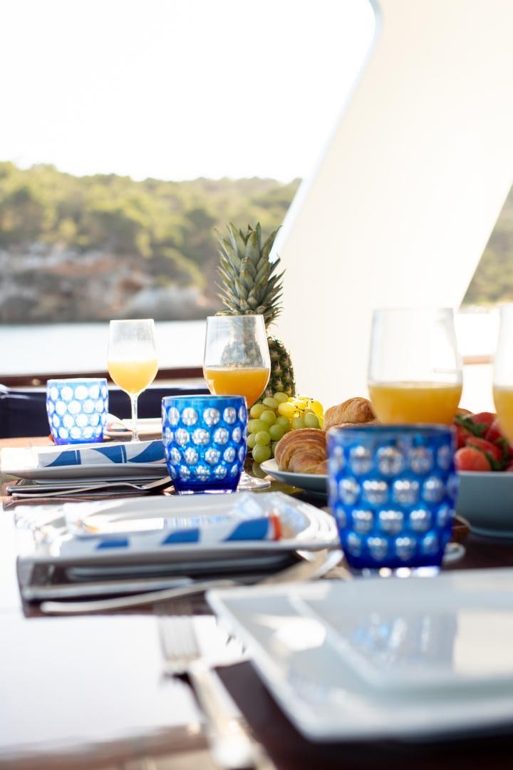 a table with food and drinks aboard MAXMARA Yacht for Sale