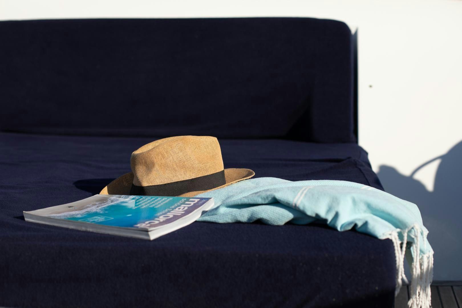 a hat on a bed aboard MAXMARA Yacht for Sale