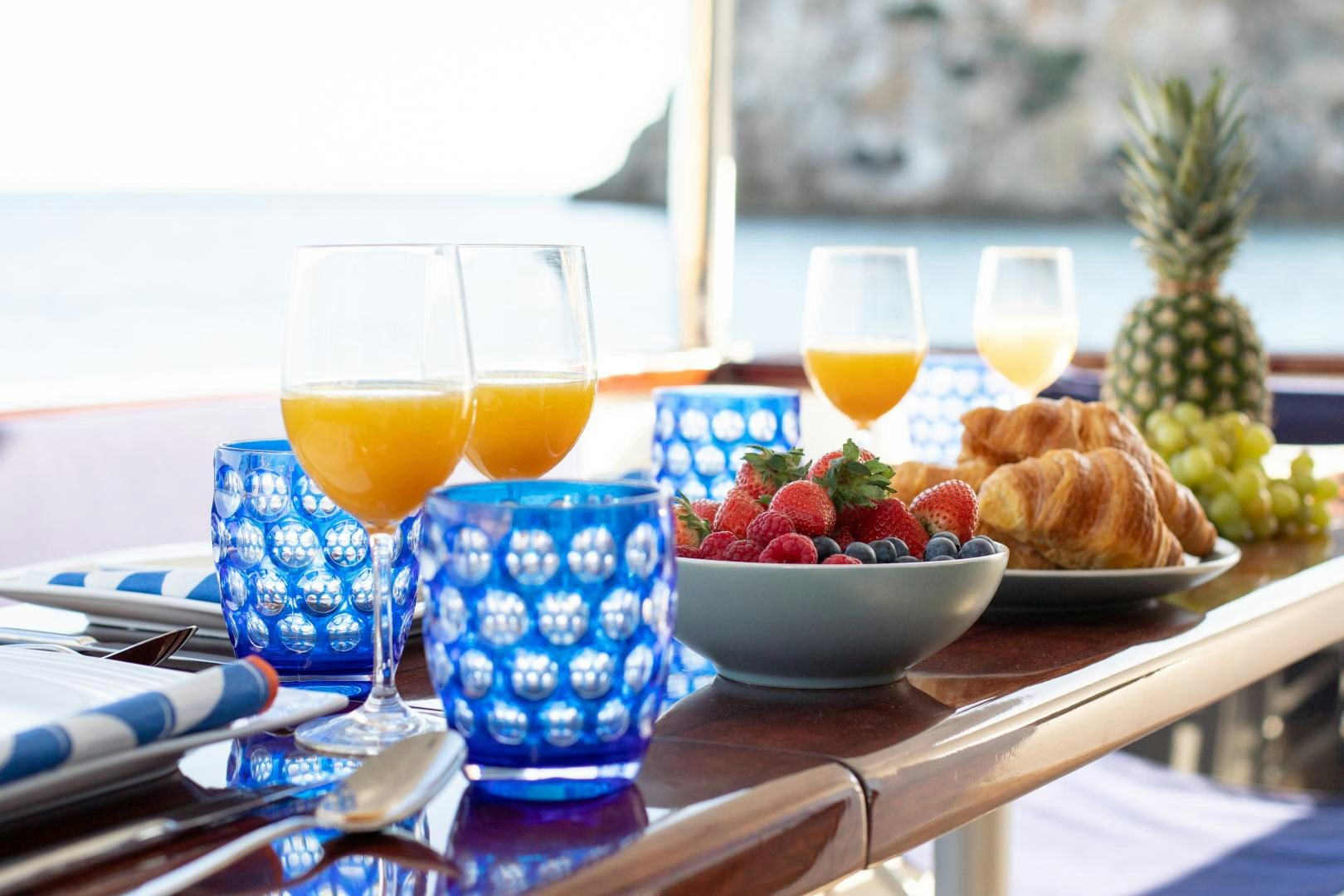 a table with food and drinks on it aboard MAXMARA Yacht for Sale