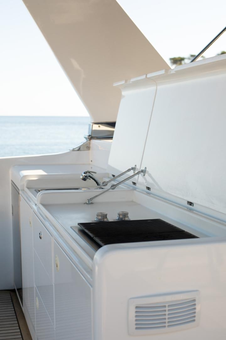 a white kitchen with a black sink aboard MAXMARA Yacht for Sale