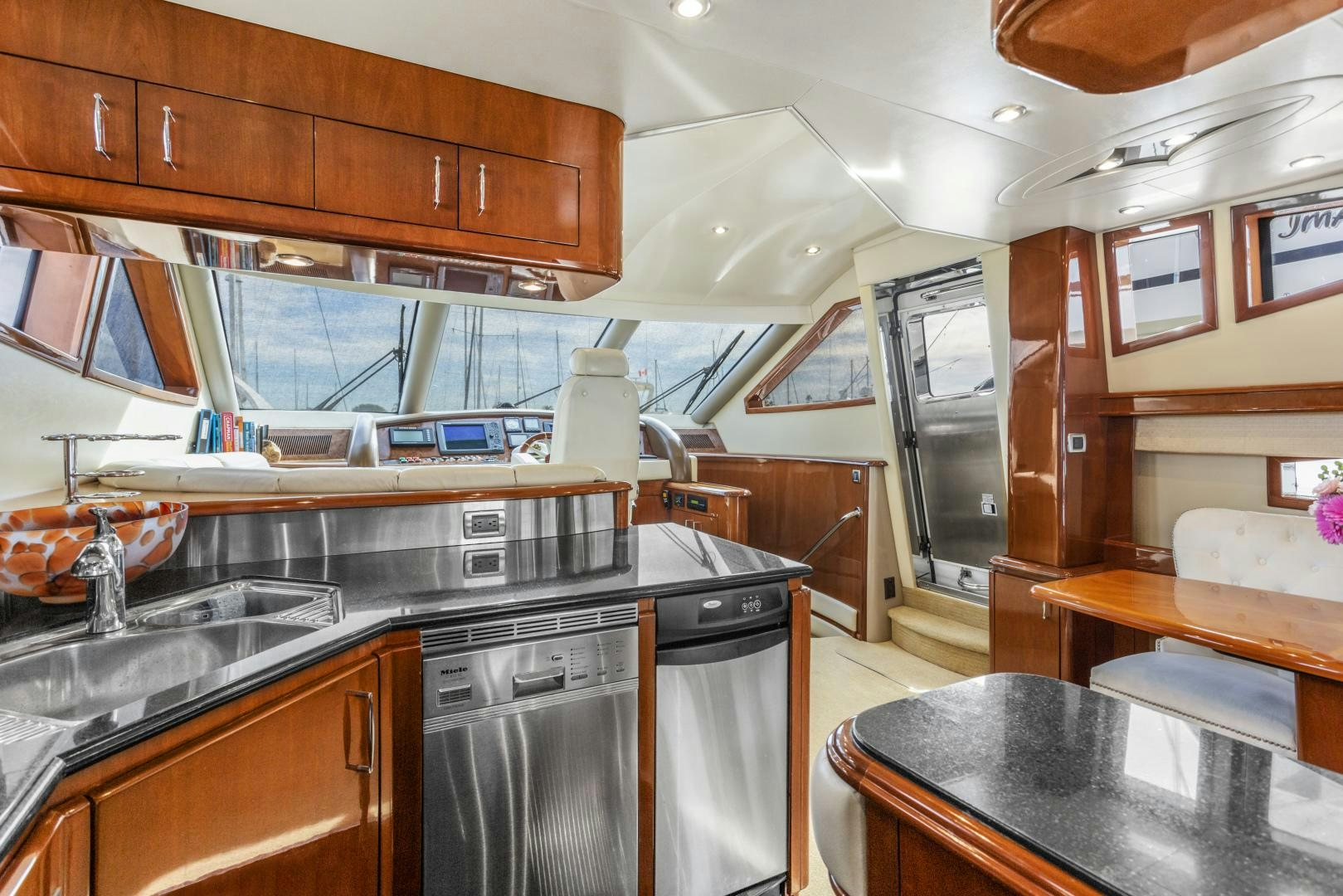 a kitchen with wooden cabinets aboard MONDRIAN Yacht for Sale