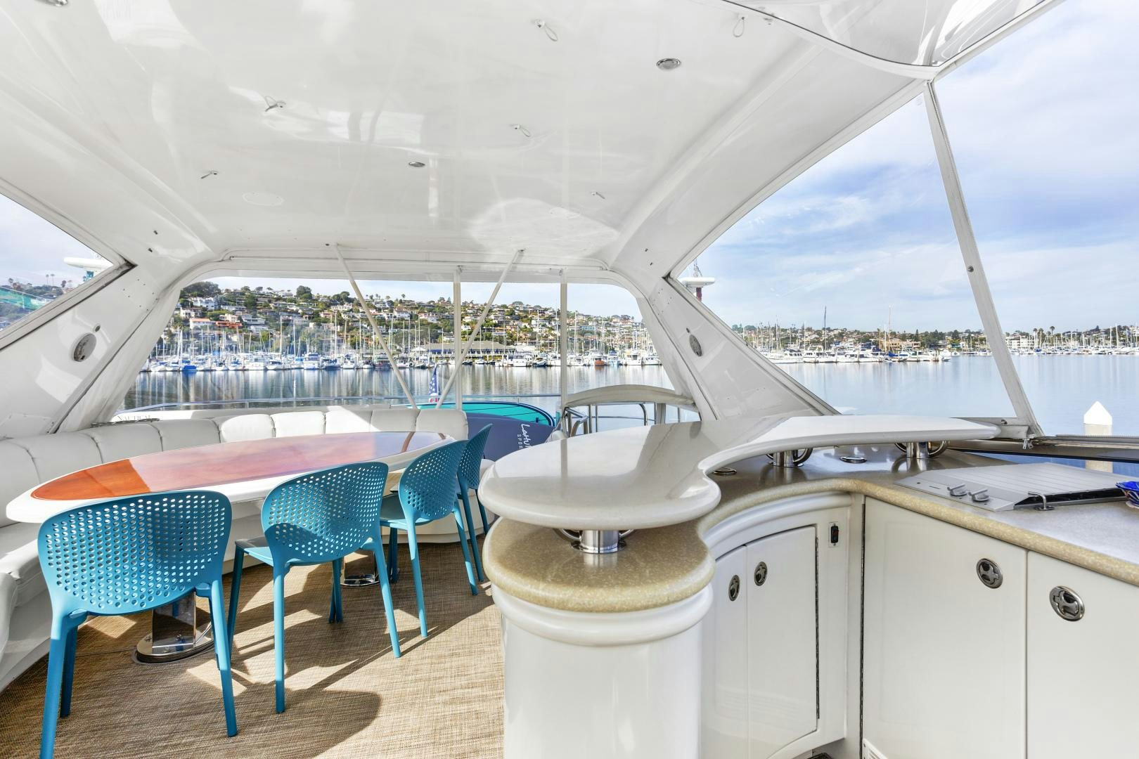 a large white boat with blue chairs aboard MONDRIAN Yacht for Sale