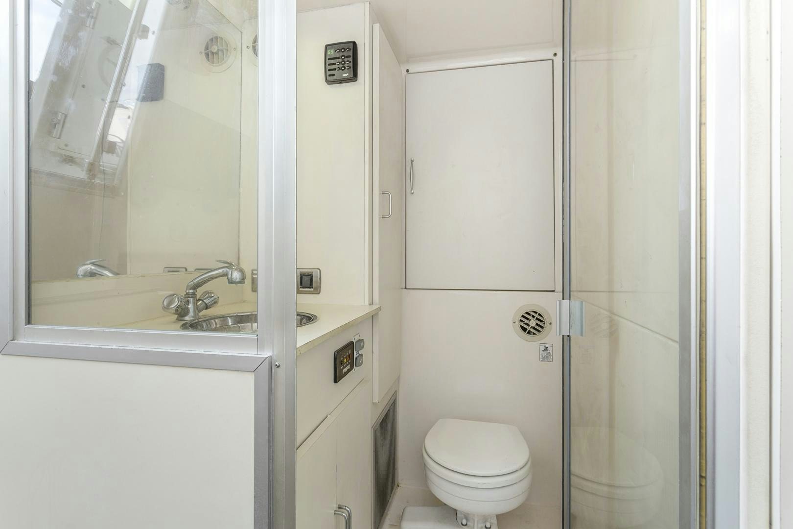 a bathroom with a toilet and sink aboard MONDRIAN Yacht for Sale