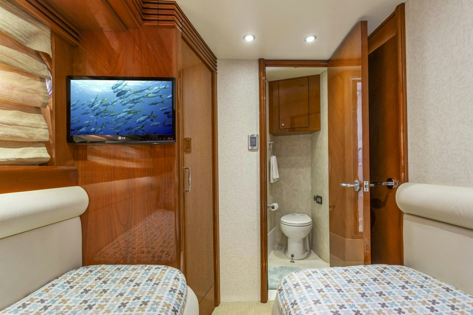 a bathroom with a bed and a television aboard MONDRIAN Yacht for Sale