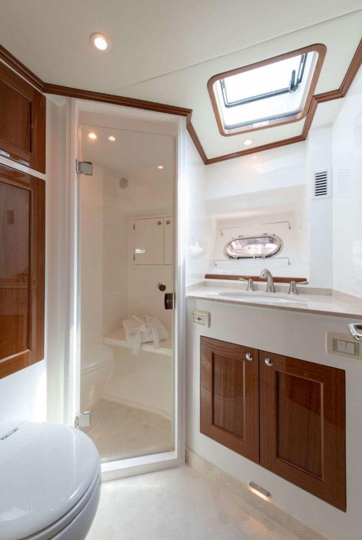 a bathroom with a shower and sink aboard OCEAN 63 Yacht for Sale