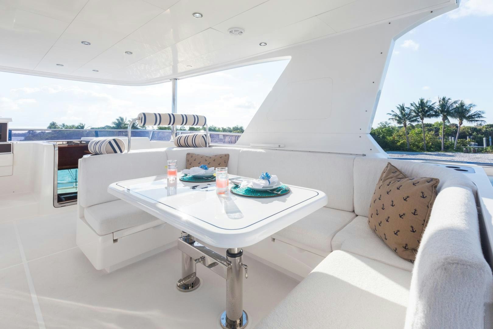 a white couch and a table in a room with a large window aboard SUNNY Yacht for Sale