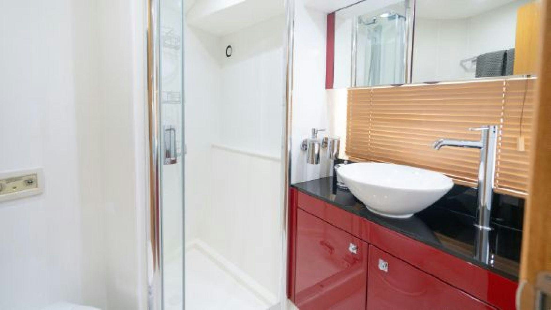 a bathroom with red cabinets aboard MANCUSA Yacht for Sale