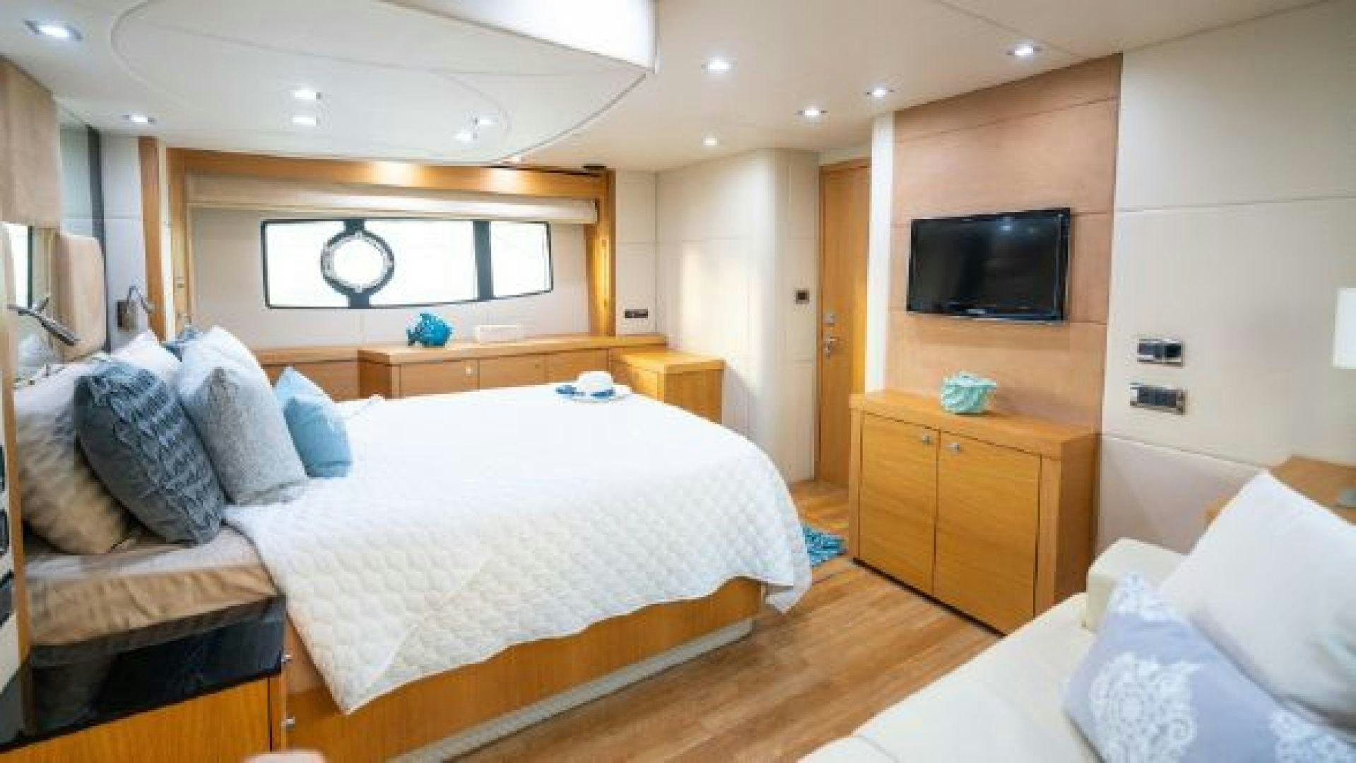 a bedroom with a bed and a television aboard MANCUSA Yacht for Sale