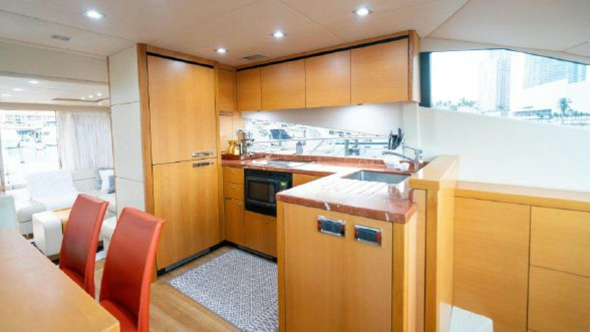 a kitchen with wooden cabinets aboard MANCUSA Yacht for Sale