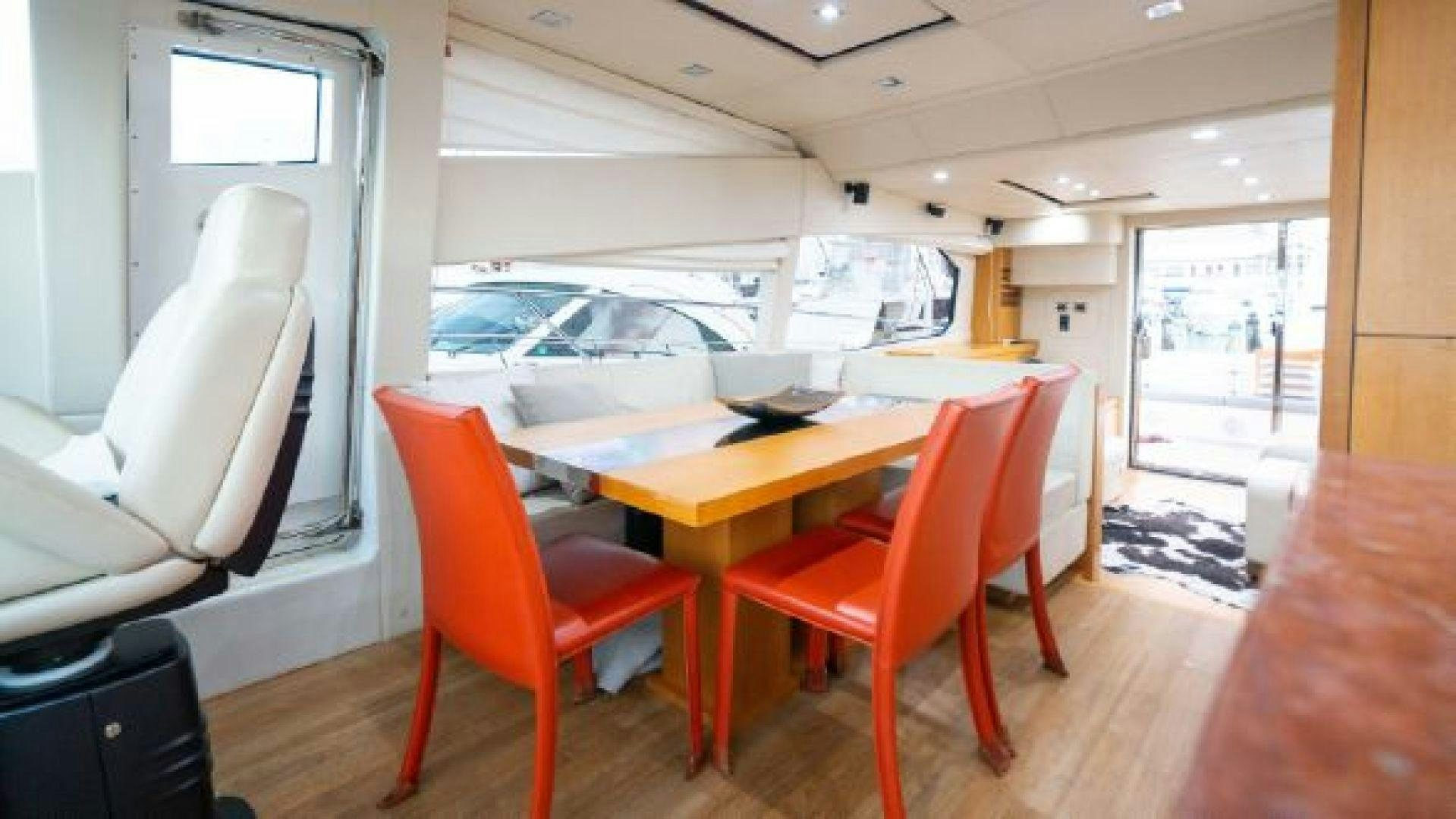 a room with a table and chairs aboard MANCUSA Yacht for Sale